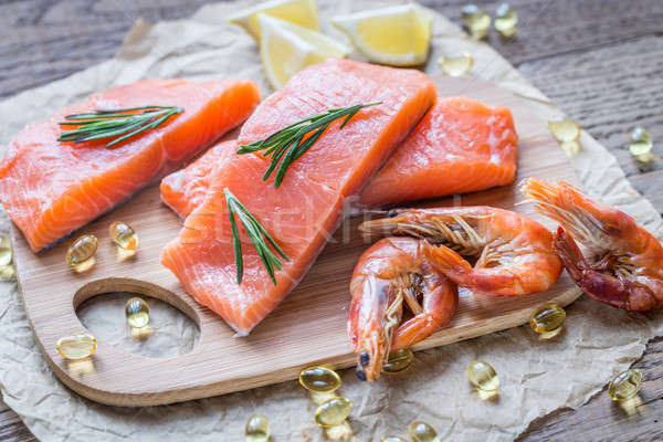 Raw salmon with shrimps on the wooden board Stock photo © Alex9500