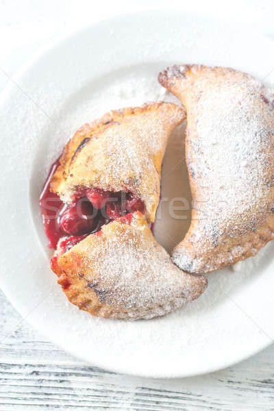 Cherry empanadas on the white plate Stock photo © Alex9500