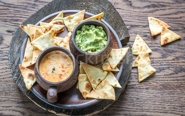Bowls of guacamole and queso with tortilla chips Stock photo © Alex9500