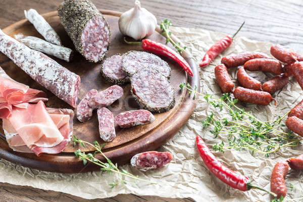 Different kinds of sausage on the wooden background Stock photo © Alex9500