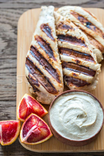 Grilled chicken with tahini sauce on the wooden board Stock photo © Alex9500