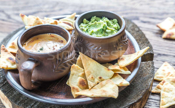 Bowls of guacamole and queso with tortilla chips Stock photo © Alex9500