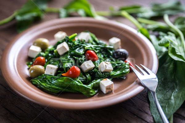 Spinach with cheese, olives and pepper drops Stock photo © Alex9500