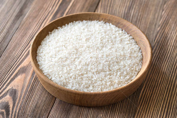 Bowl of uncooked camolino rice Stock photo © Alex9500