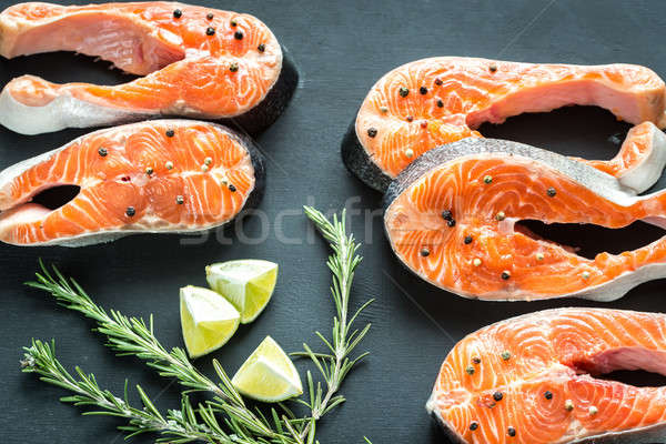 Stock photo: Raw trout steaks on the wooden board