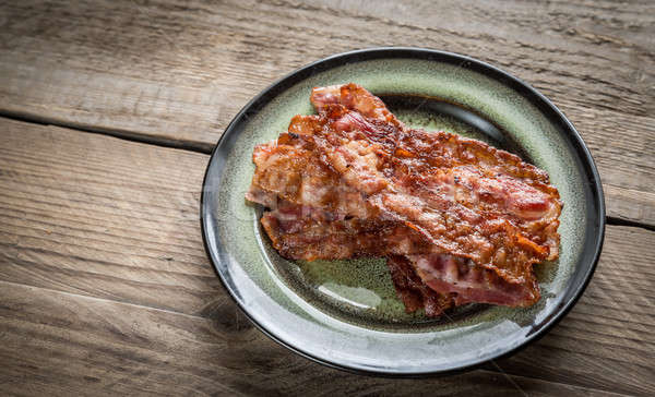 Stack of fried bacon strips on the plate Stock photo © Alex9500