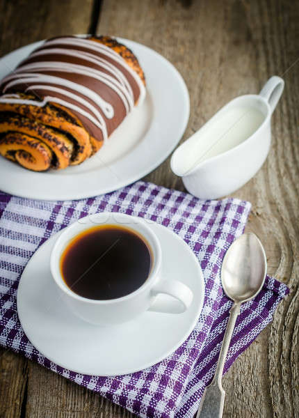 Cup of coffee and poppy bun glazed with ganache Stock photo © Alex9500