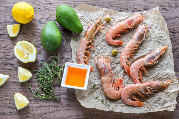 Raw shrimps with avocado and lemon wedges Stock photo © Alex9500