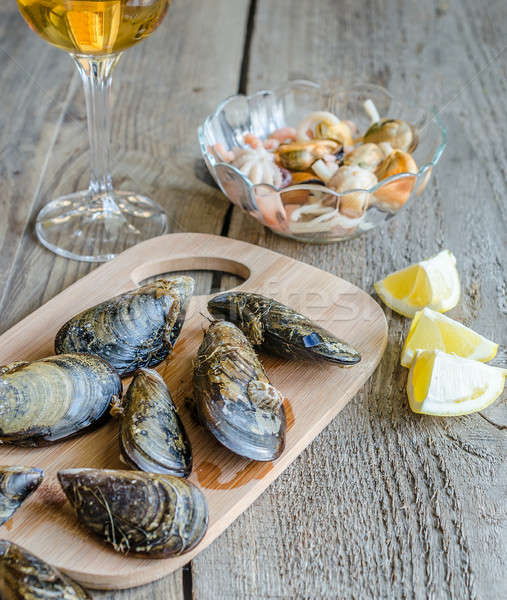 Mussels with a glass of white wine on the wooden table Stock photo © Alex9500