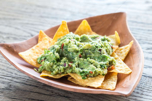 Stock photo: Guacamole with tortilla chips on the wooden background