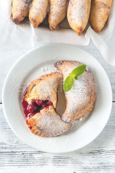 Cherry empanadas on the white plate Stock photo © Alex9500