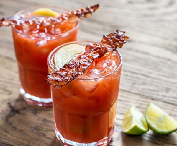 Two glasses of Bloody Mary with bacon rashers Stock photo © Alex9500