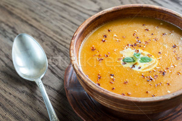 Bowl of spicy pumpkin cream soup on the wooden table Stock photo © Alex9500
