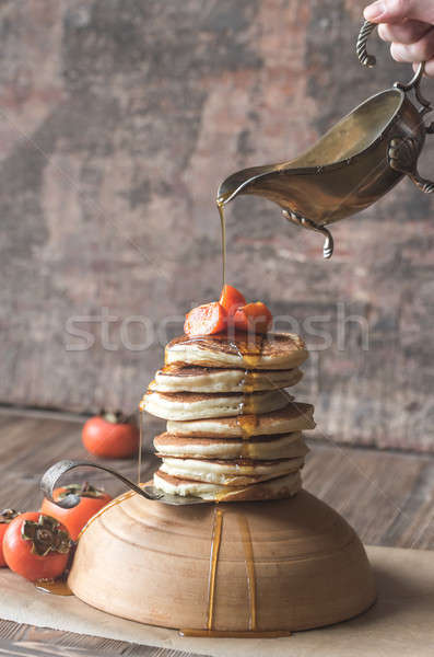 Pancakes with fresh persimmon and maple syrup Stock photo © Alex9500