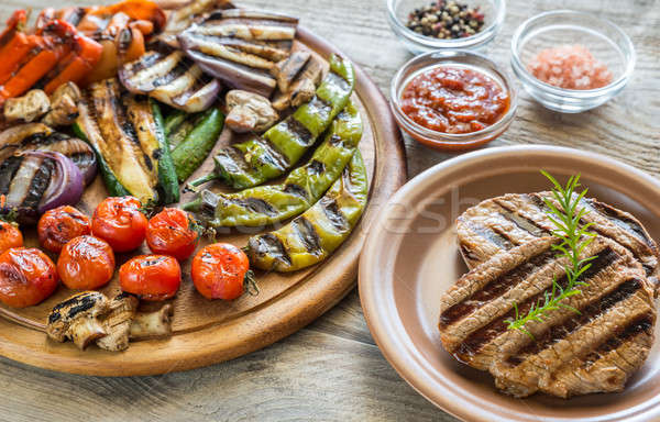 Grilled vegetables with beef steak on the wooden board Stock photo © Alex9500