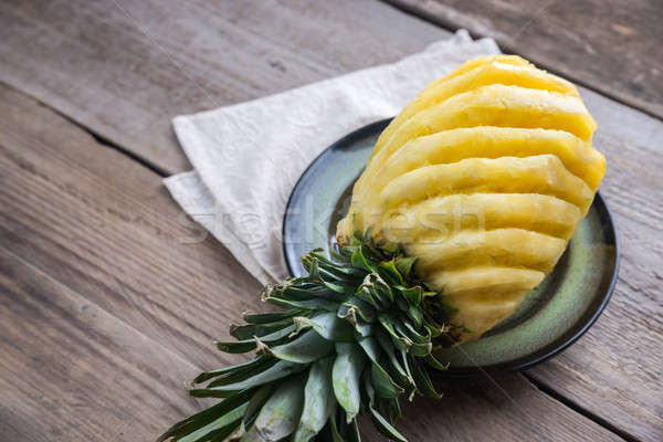 Pineapple on the plate on the wooden background Stock photo © Alex9500