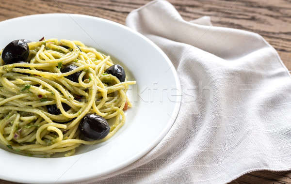 Pasta with guacamole sauce and black olives Stock photo © Alex9500