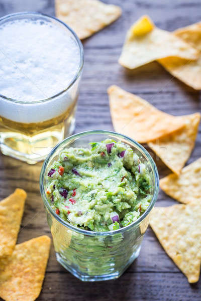 Guacamole with tortilla chips and glass of beer Stock photo © Alex9500