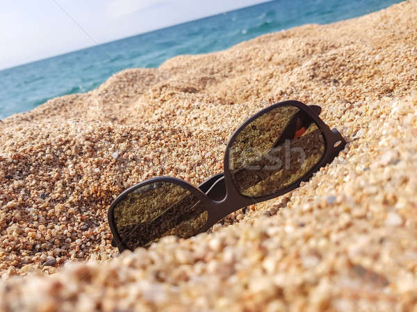 Sunglasses on the sand beach Stock photo © Alex9500