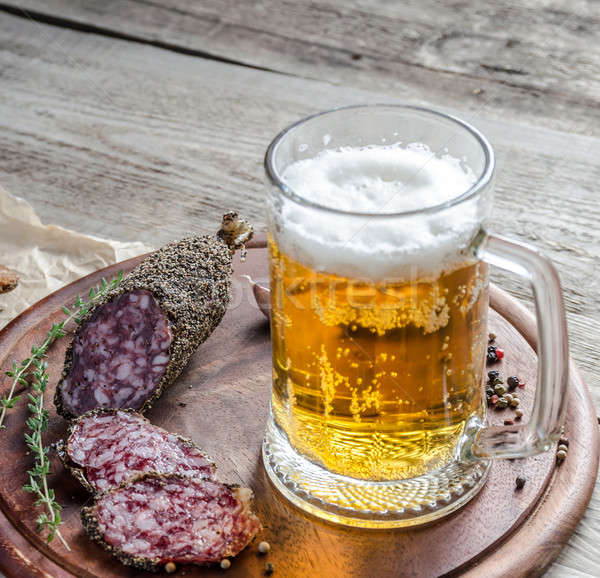 Szeletek francia kolbász üveg sör asztal Stock fotó © Alex9500