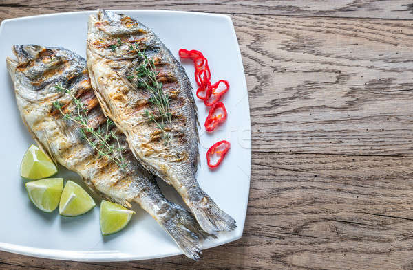 Grilled Dorade Royale Fish on the plate Stock photo © Alex9500