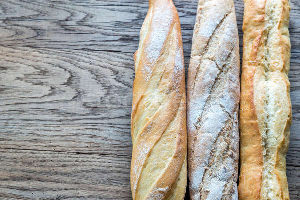 Three baguettes on the wooden background Stock photo © Alex9500