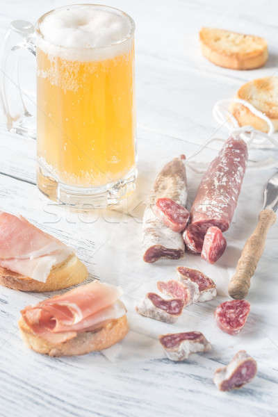 Mug of beer with sandwiches and smoked sausage Stock photo © Alex9500