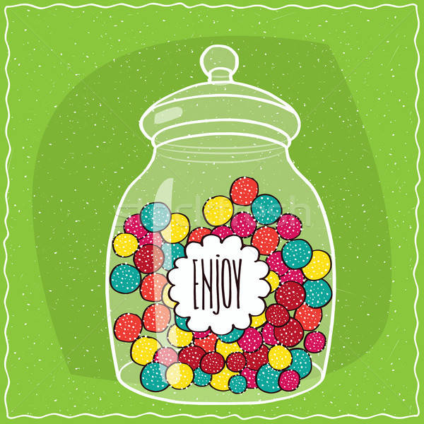 Glass jar with colorful round candies inside Stock photo © alexanderandariadna