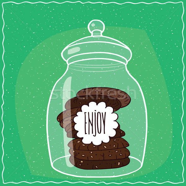 Glass jar with stack of chocolate cookies inside Stock photo © alexanderandariadna