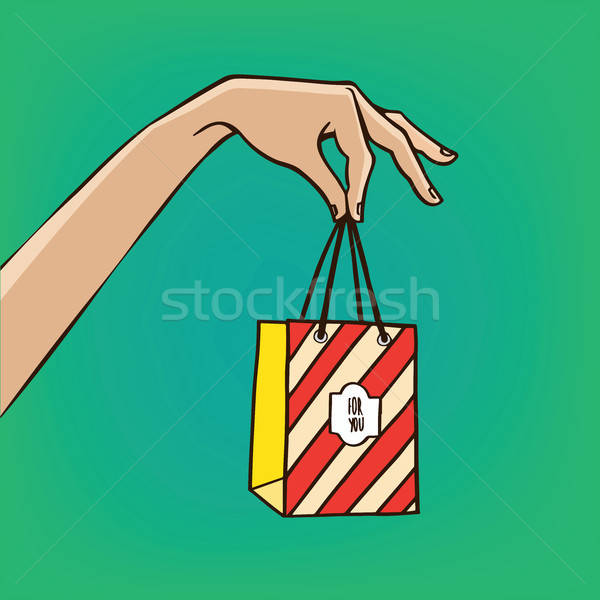 Outstretched hand with gift bag Stock photo © alexanderandariadna