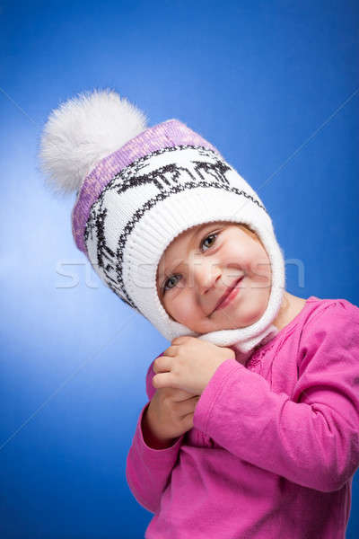 Portrait of an adorable baby girl wearing a knit pink and white winter hat.  Stock photo © alexandkz