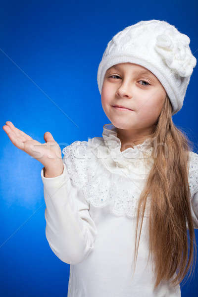 Portrait of an adorable baby girl wearing white winter hat.  Stock photo © alexandkz