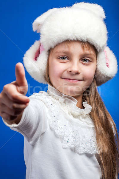 Portrait of an adorable baby girl wearing pink and white winter hat.  Stock photo © alexandkz