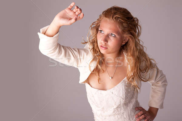 Stock photo: beautiful woman, looking up protection with the arm from the light