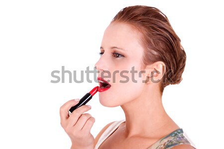 beautiful and happy middle-aged woman putting lipstick, isolated on white background, studio shot Stock photo © alexandrenunes