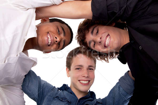 three young man of different colors,looking to camera and smiling, view from below Stock photo © alexandrenunes