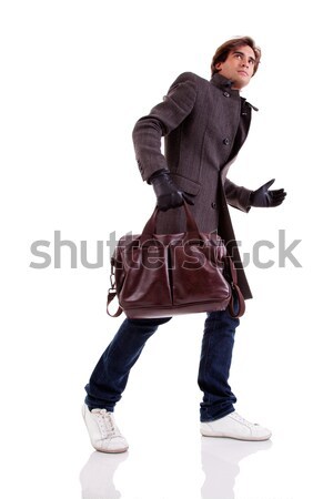 Portrait of a young man with a handbag, hasty, in autumn/winter clothes Stock photo © alexandrenunes