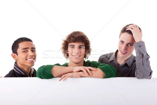 happy three young, of different colors man with a white board Stock photo © alexandrenunes