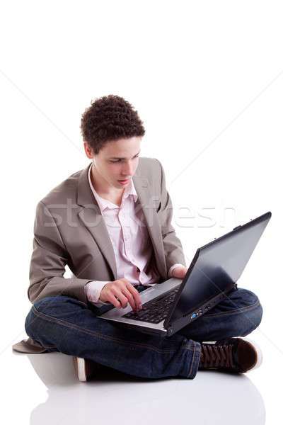 young man typing and looking at screen of laptop