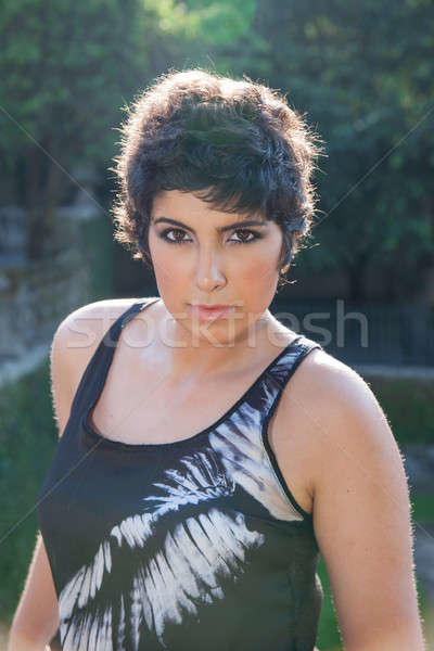 beautiful young woman, looking to camera, with sunbeam reflexion, outside Stock photo © alexandrenunes