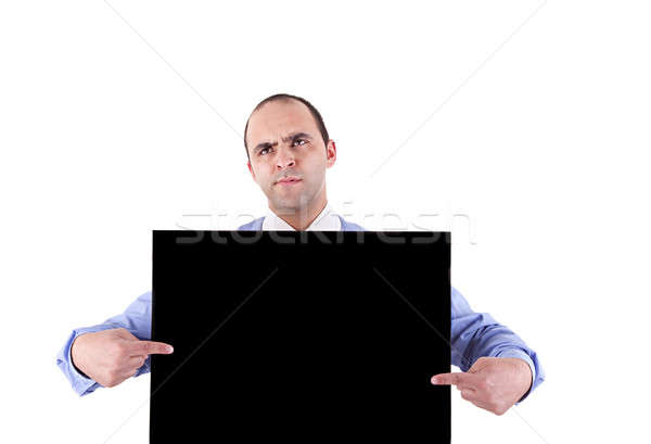 young business man holding a blackboard and pointing with both hands, looking bored Stock photo © alexandrenunes