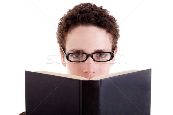 Young man with glasses, peering over an open book Stock photo © alexandrenunes