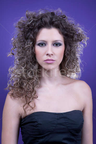young and beautiful woman, with curly hair, on purple background, studio shot Stock photo © alexandrenunes