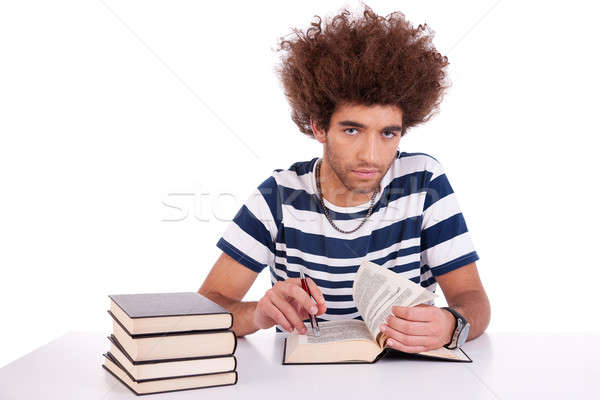 handsome young man studying and reading a book on his desk, Stock photo © alexandrenunes