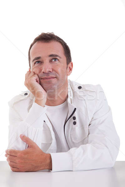 Portrait of a handsome middle-age man smiling and looking up, on white background. Studio shot Stock photo © alexandrenunes