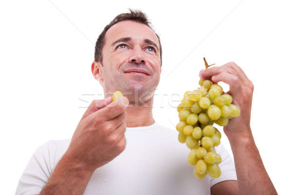 Bel homme manger raisins verts isolé blanche Photo stock © alexandrenunes