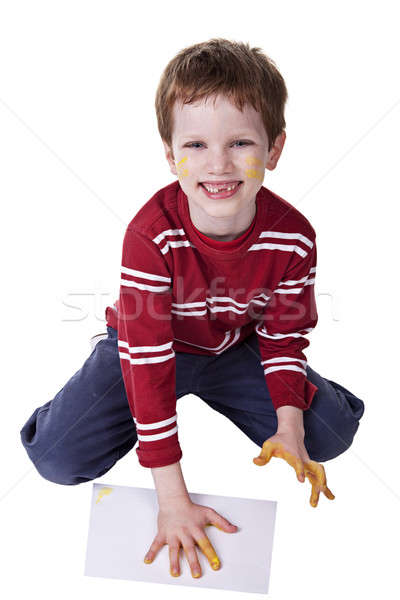 Children playing with paint, stamping his hand on a white sheet Stock photo © alexandrenunes