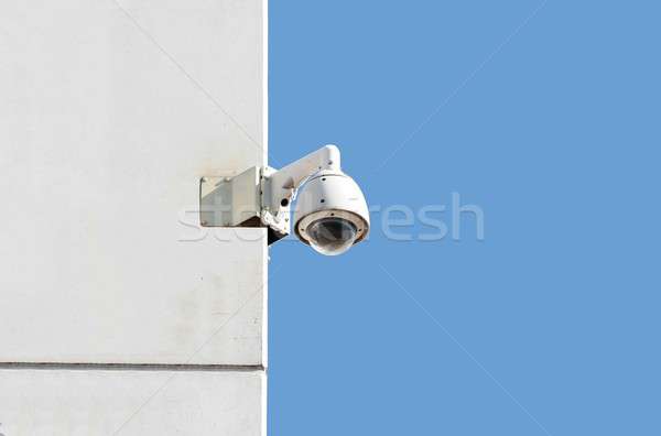 surveillance camera at a white wall with blue sky background Stock photo © alexandrenunes