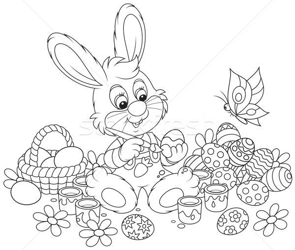 Little Bunny paints Easter eggs Stock photo © AlexBannykh