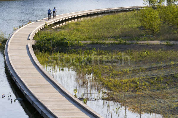 Stock photo: Bicycling on boardwalk